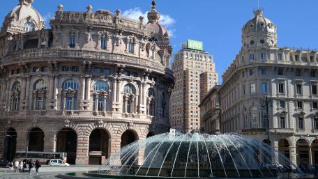 Charming City Square with Elegant Architecture and Fountain wallpaper