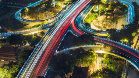 Vibrant Night Light Trails Over A Busy Junction wallpaper