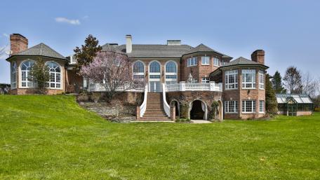 Stunning Mansion Surrounded by Lush Greenery and Scenic Views wallpaper