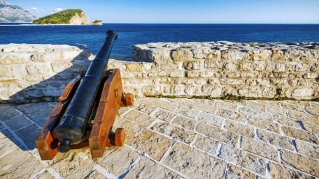 Coastal Cannon Overlooking Tranquil Waters wallpaper