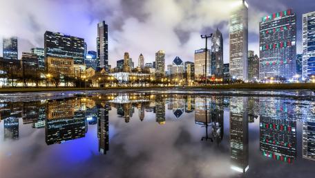City Skyline Reflected in Water at Night wallpaper
