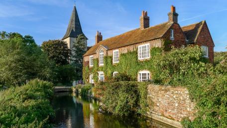 Picturesque Village by the Waterway with Historic Tower wallpaper