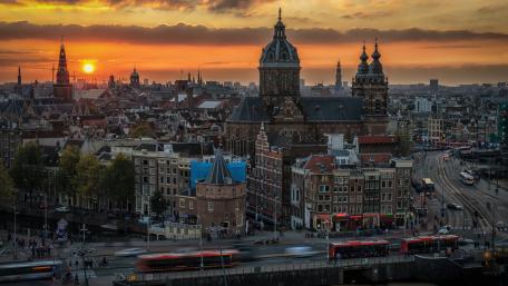 Stunning Sunset Over Amsterdam's Historic Skyline wallpaper