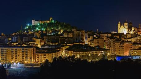 Night view of a vibrant city skyline with historical architecture. wallpaper