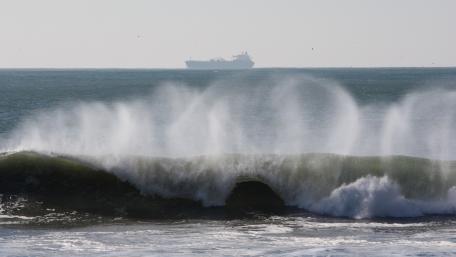 Breaking Wave with a Ship in the Distance wallpaper