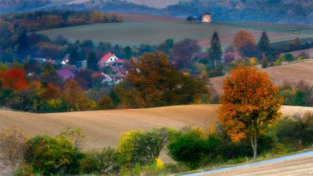 Serene Autumn Landscape with Vibrant Colors and Rolling Hills wallpaper