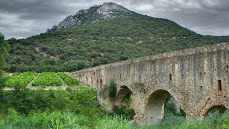 Ancient Bridge Amidst Lush Hillside Scenic View wallpaper