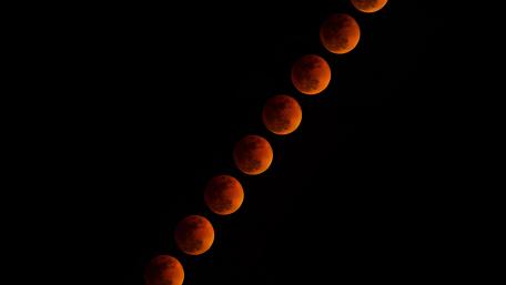 Captivating Lunar Phases in Orange Hue wallpaper