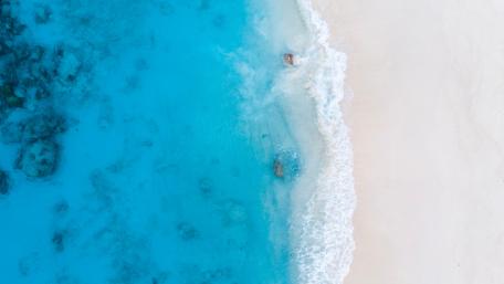 Aerial View of Pristine Blue Beach wallpaper