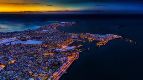 Vibrant Cityscape at Dusk Overlooking the Ocean wallpaper