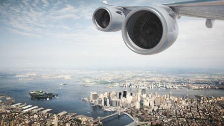 Aerial View of a Vibrant Cityscape Through a Jet Engine wallpaper