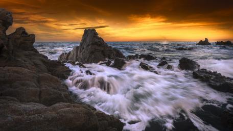 Serene Sunset Over Rocky Coastline wallpaper