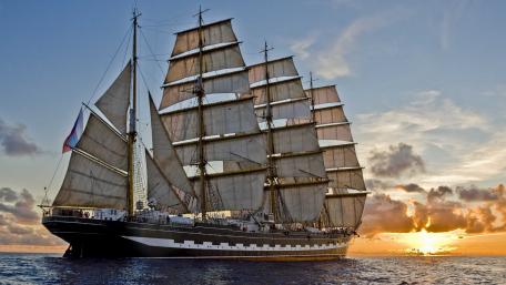 Majestic Masted Ship Sailing at Sunset wallpaper