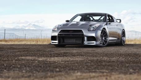 Sleek Silver Sports Car Against a Mountain Backdrop wallpaper