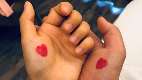 Hearts on Hands Sharing Love and Connection wallpaper