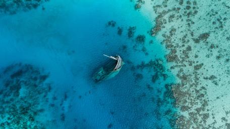 Shipwreck Among Vibrant Azure Waters wallpaper