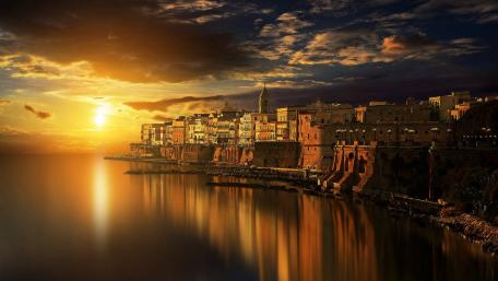 Golden Dusk Over Cityscape Reflection in Water wallpaper