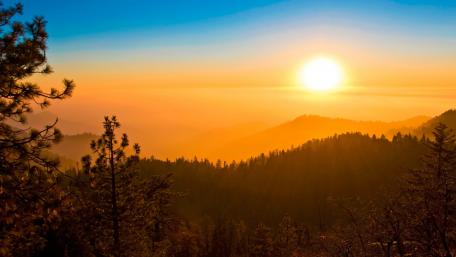 Golden Sunrise Over Lush Mountainscape wallpaper