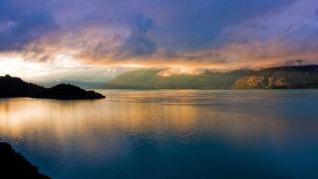 Tranquil Lake Under Dramatic Skies wallpaper