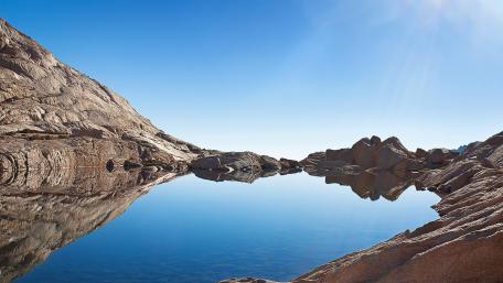 Serene Blue Lake Reflection in Nature's Embrace wallpaper