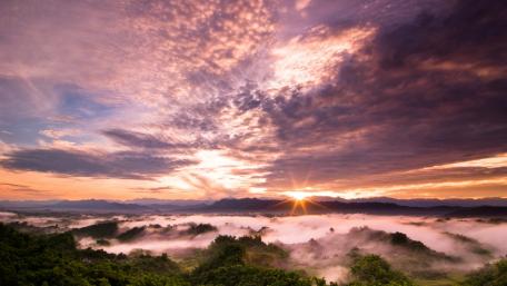 Stunning Sunset Over Purple Foggy Landscape wallpaper