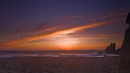 Tranquil Beach Sunset Over the Horizon wallpaper