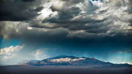 Majestic Mountains Under a Dramatic Sky wallpaper