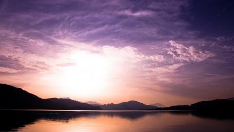 Serene Purple Dusk Over Tranquil Lake wallpaper