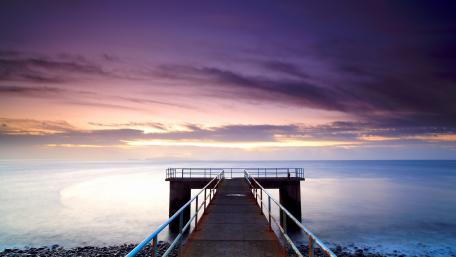 Serene Pier at Sunset Over Calm Waters wallpaper