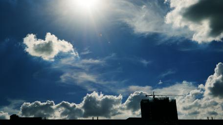 Vibrant City Skyline Under Bright Sky wallpaper