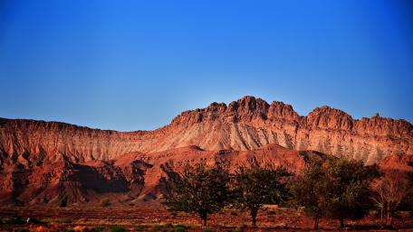 Stunning Badlands Under Clear Blue Sky wallpaper