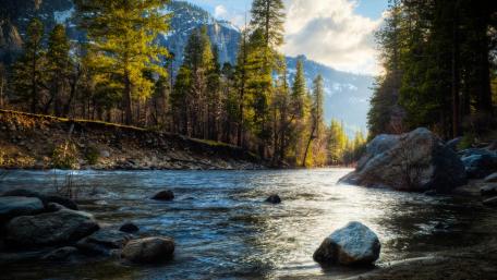 Serene Mountain River in Wilderness Beauty wallpaper