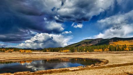 Tranquil Lake Under Dramatic Skies wallpaper