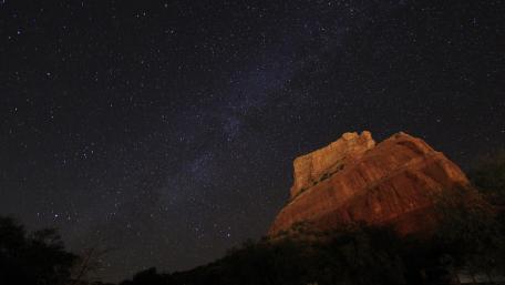 Starlit Serenity Over Majestic Mountain Formation wallpaper