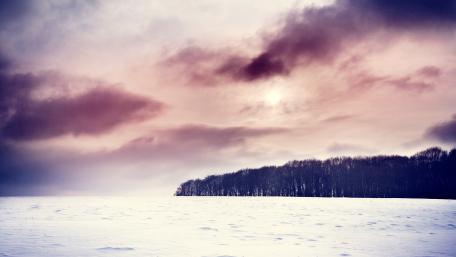 Serene Winter Landscape with Cloudy Skies wallpaper