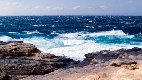 Majestic Ocean Waves Crashing on Rocky Coastline wallpaper