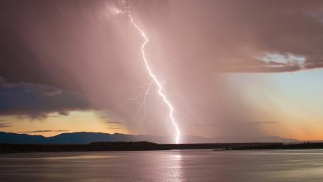 Striking Beauty of Lightning Over Waterfront Scene wallpaper
