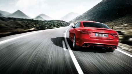 Red Audi Racing Down the Open Highway wallpaper