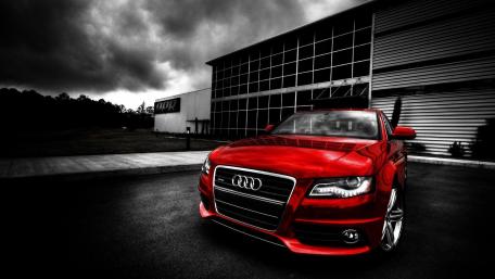 Striking Red Audi Against Industrial Backdrop wallpaper