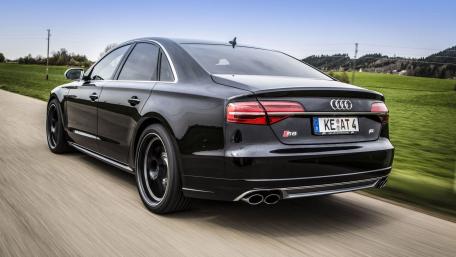 Sleek Audi Driving Through Scenic Landscape wallpaper