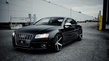 Sleek Black Audi Coupe in Urban Setting wallpaper