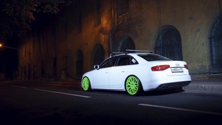 Sleek Audi on Neon Green Wheels at Night wallpaper