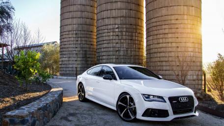 Sleek Audi RS7 Against Rustic Silos wallpaper