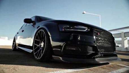 Sleek Black Car with Stunning Custom Wheels wallpaper