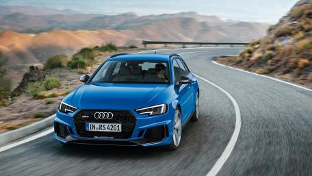 Dynamic Blue Audi on Scenic Mountain Road wallpaper