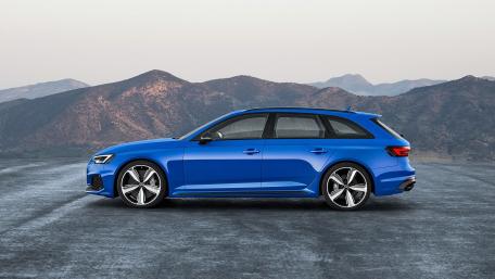 Sleek Blue Car Against Mountain Backdrop wallpaper