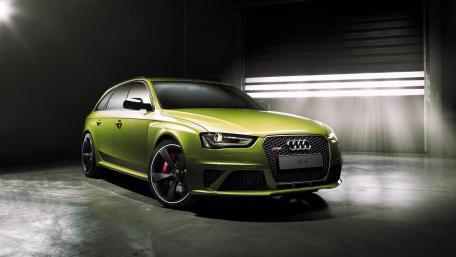 Sleek Green Audi RS4 on Display in Warehouse Lighting wallpaper