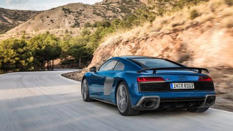 Sleek Audi R8 Racing Through Serene Landscapes wallpaper