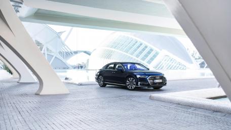 Sleek Luxury Car in Modern Architectural Setting wallpaper