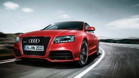Sleek Red Audi Sports Car on Dynamic Curve wallpaper